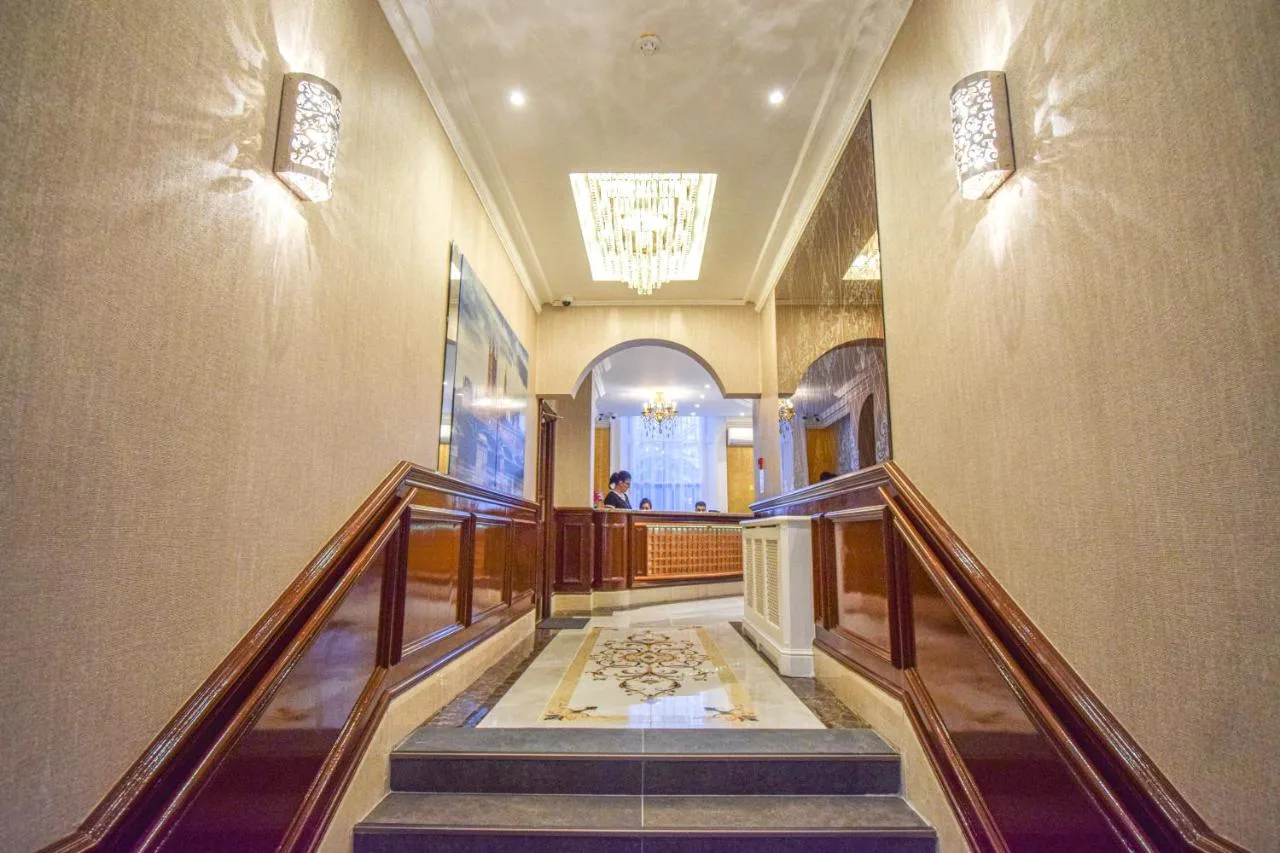 a hallway with a staircase in a building at Pembridge Palace Hotel in London